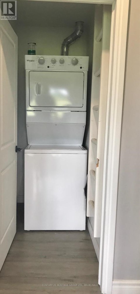 A white dishwasher is installed in a narrow kitchen space.