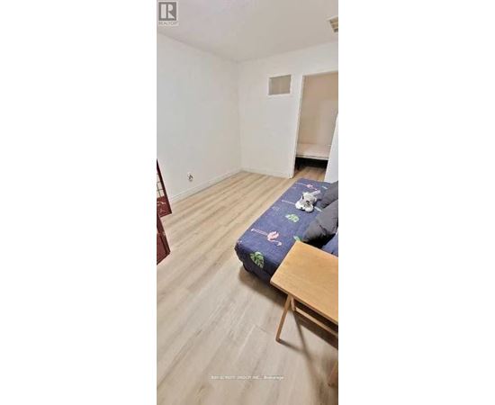 A bedroom with a bed and a wooden table.