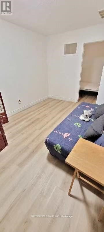 A bedroom with a bed and a wooden table.