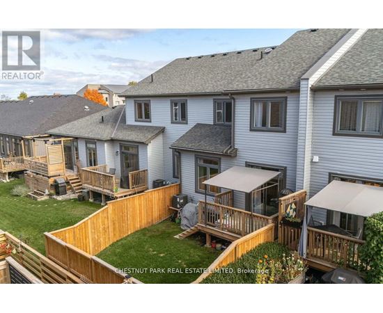 A real estate company is advertising a property with a well-maintained lawn and deck.