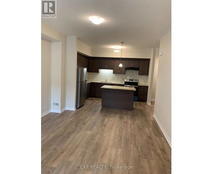A kitchen with wooden floors and white walls.