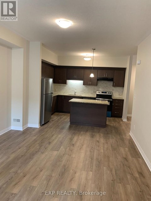 A kitchen with wooden floors and white walls.