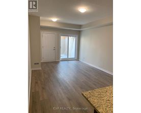 A room with wooden flooring and a sliding glass door.