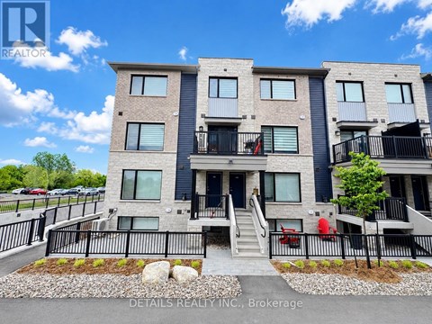 A modern apartment building with a clear blue sky in the background.