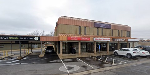 A parking lot in front of a building with a sign that says Town Medipa.