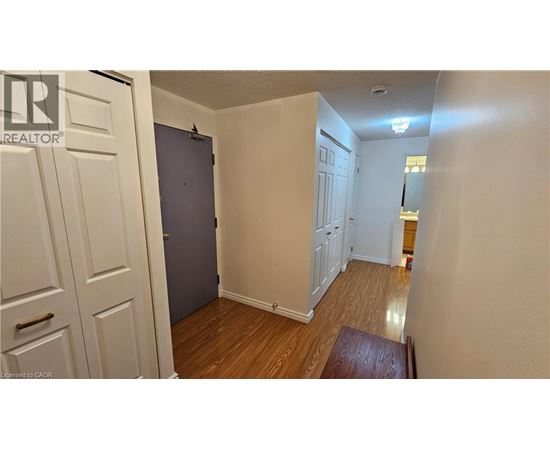 A room with a wooden floor and white walls.