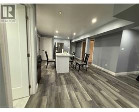 A room with a wooden floor and a white cabinet.