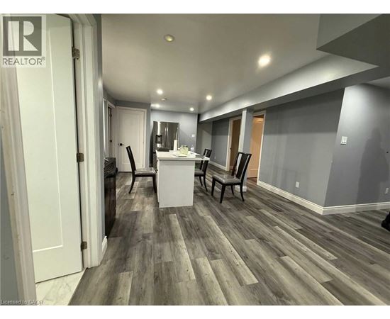 A room with a wooden floor and a white cabinet.