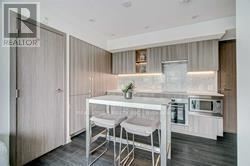 A modern kitchen with a white table and chairs.