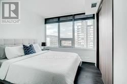 A bedroom with a large bed and a window.