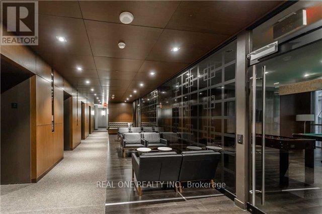 A long hallway with glass doors and a Realty logo.