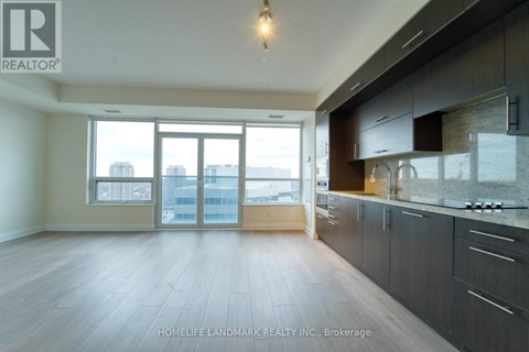 A spacious kitchen with dark wood cabinets and a large window overlooking the city.