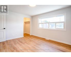 A room with a door and a window with a white frame.