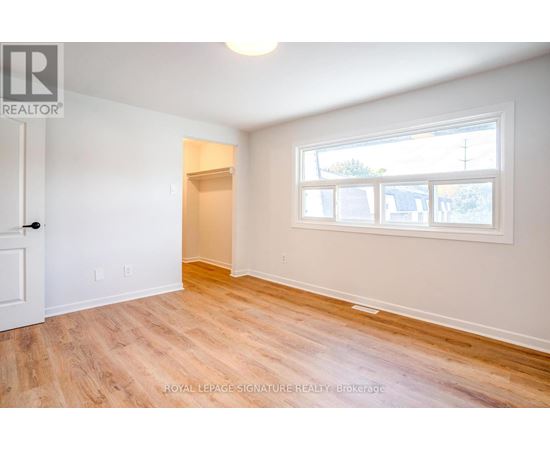 A room with a door and a window with a white frame.