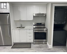 A kitchen with white cabinets and stainless steel appliances.