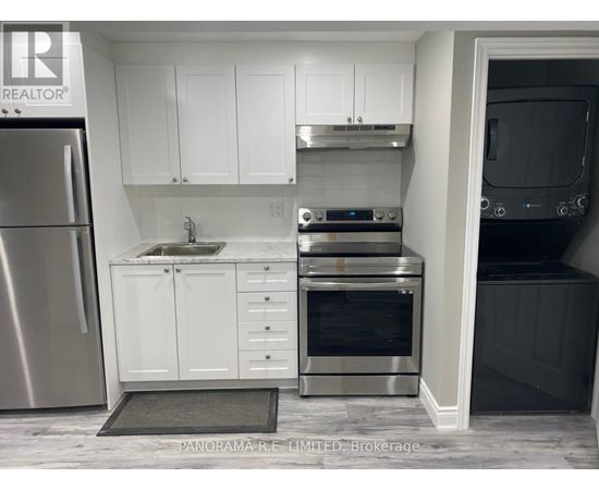 A kitchen with white cabinets and stainless steel appliances.