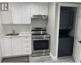 A kitchen with white cabinets and stainless steel appliances.