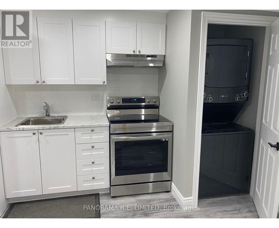 A kitchen with white cabinets and stainless steel appliances.