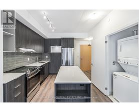 A modern kitchen with dark wood cabinets and stainless steel appliances.
