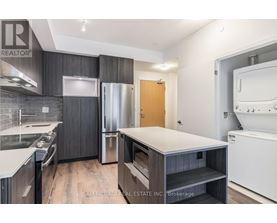 A kitchen with a refrigerator, oven, and dishwasher.