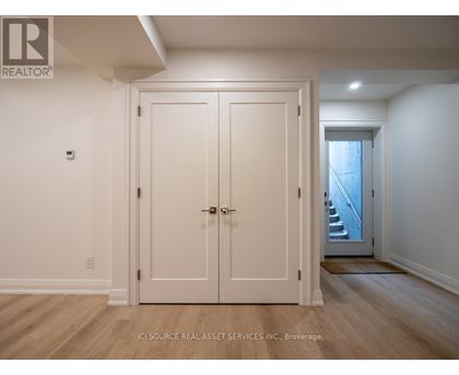 A white door with a handle and a lock is closed.