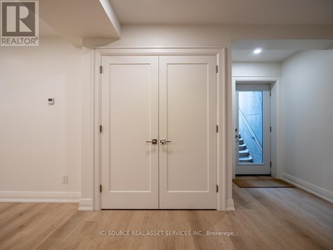 A white door with a handle and a lock is closed.