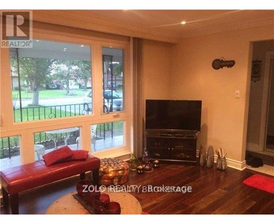A living room with a red couch and a television.
