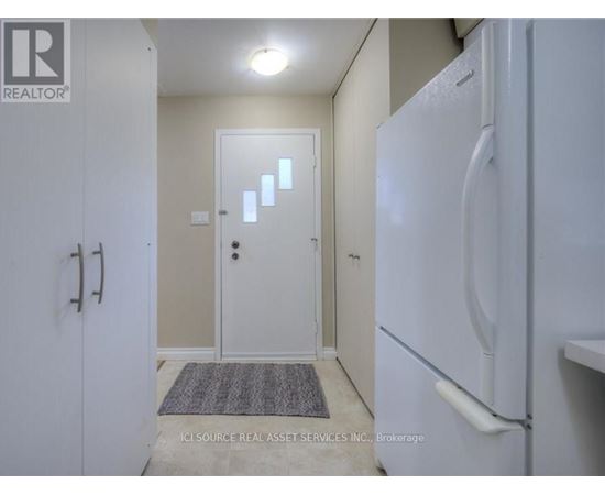A white refrigerator in a kitchen with a door open.