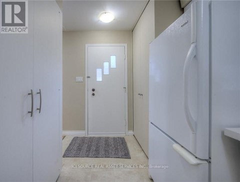 A white refrigerator in a kitchen with a door open.