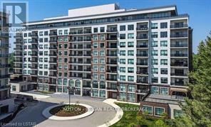 A modern multi-story residential building with a circular driveway in front.
