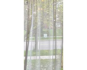 A view of a street through a window with a curtain.