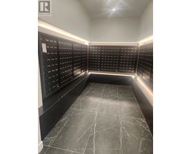 A black and white image of a room with a list of names on the wall.