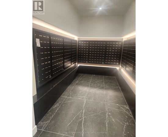 A black and white image of a room with a list of names on the wall.