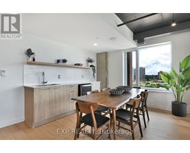 A modern kitchen with a dining table set for four.