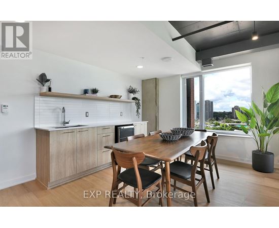 A modern kitchen with a dining table set for four.