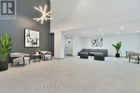 A modern living room with a grey couch and a white chair.