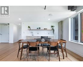 A dining room with a table set for six.