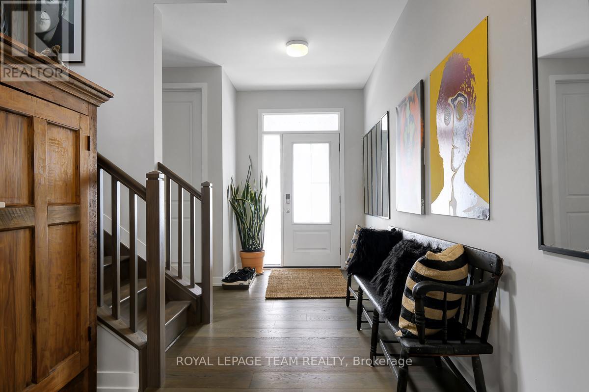 A hallway with a bench and a potted plant.