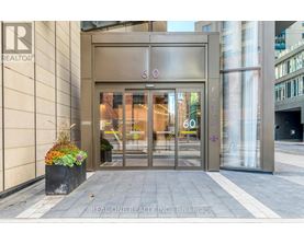 The entrance to a building with a glass door and a sign that reads "REALTOR".