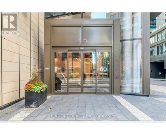 The entrance to a building with a glass door and a sign that reads "REALTOR".