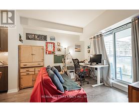 A bedroom with a bed, desk, and chair.