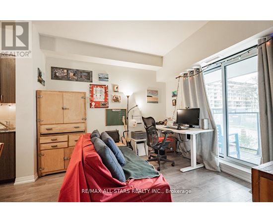A bedroom with a bed, desk, and chair.