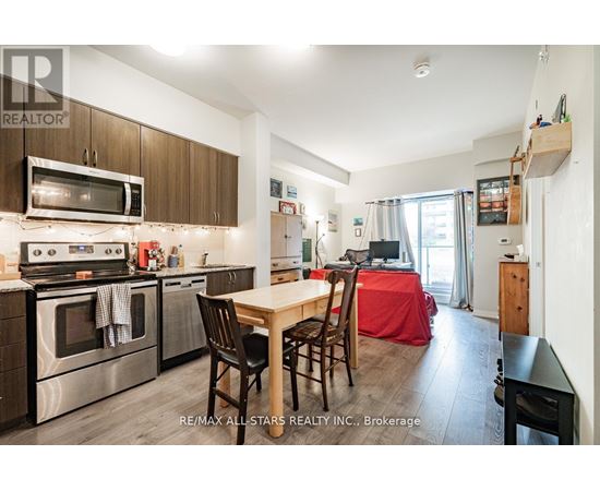 A kitchen with a table and chairs in the middle of the room.