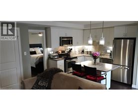 A modern kitchen with a dining table and chairs.