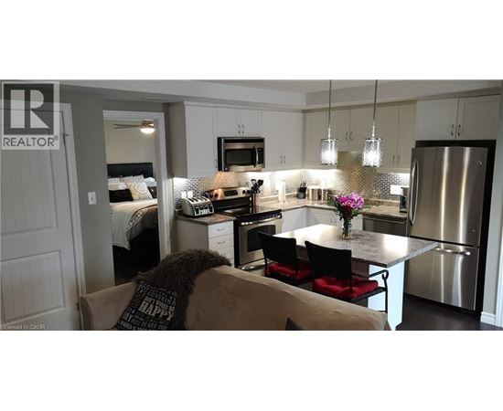 A modern kitchen with a dining table and chairs.