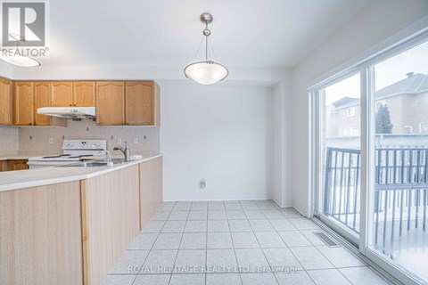 A kitchen with wooden cabinets and a white countertop.