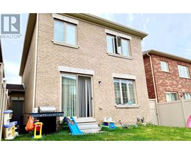 A house with a brown brick exterior and a white door.