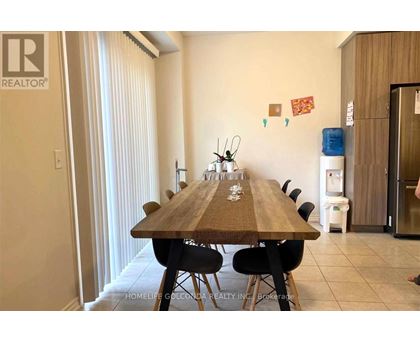 A dining room with a long table and chairs.