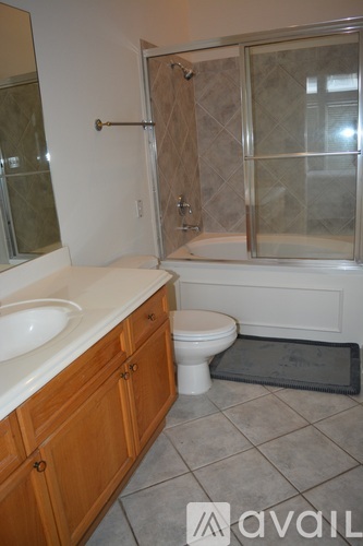 A bathroom with a toilet, sink, and shower.