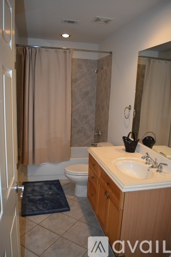 A bathroom with a toilet, sink, and shower.